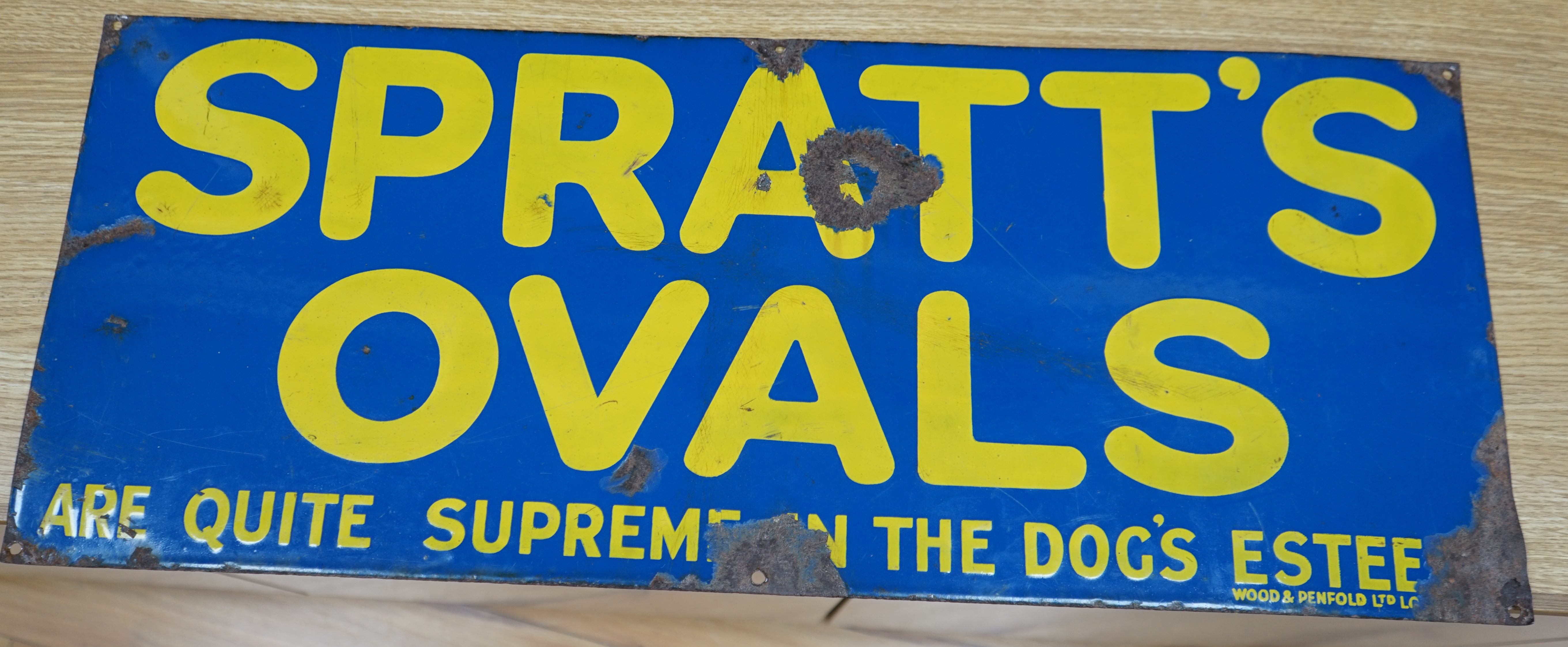 An advertising enamel sign, Spratts Ovals are quite the Supreme in the Dog's Esteem, Wood & Penfold Ltd., 30.5 x 76cm. Condition - poor to fair, several losses as photographed